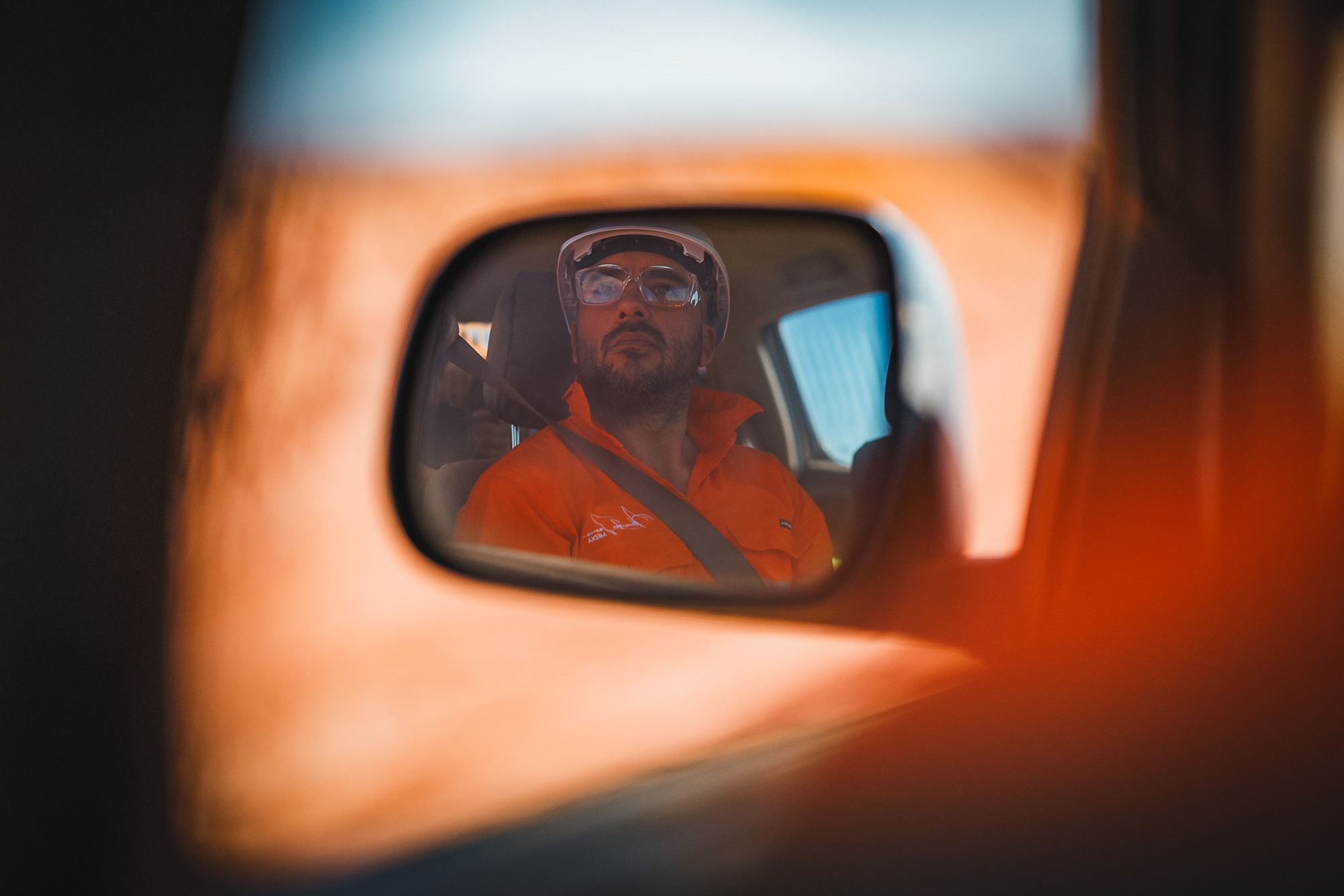 AJM crew member reflected in a ute mirror on site